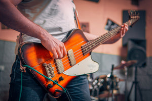 person playing a bass guitar
