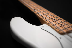 close up image of the neck of a bass guitar