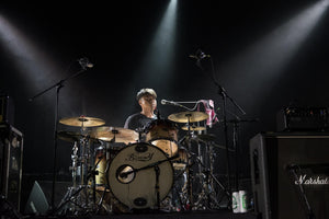 person playing drums on a stage