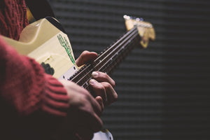 Person playing a guitar with a blurred background