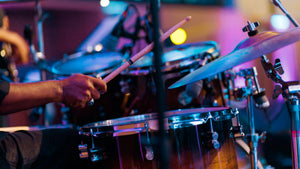 Person playing drums with a blurred background