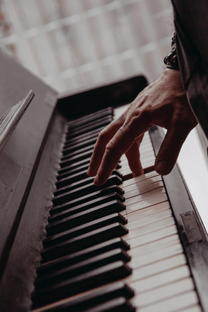 a person playing the piano with one hand