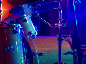 a close up shot of a drum kit set up on a stage